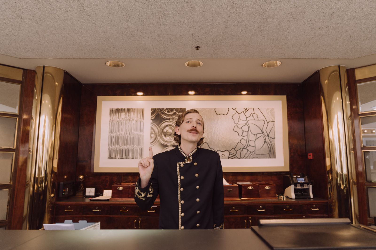 Hotel receptionist in uniform at a premium front desk
